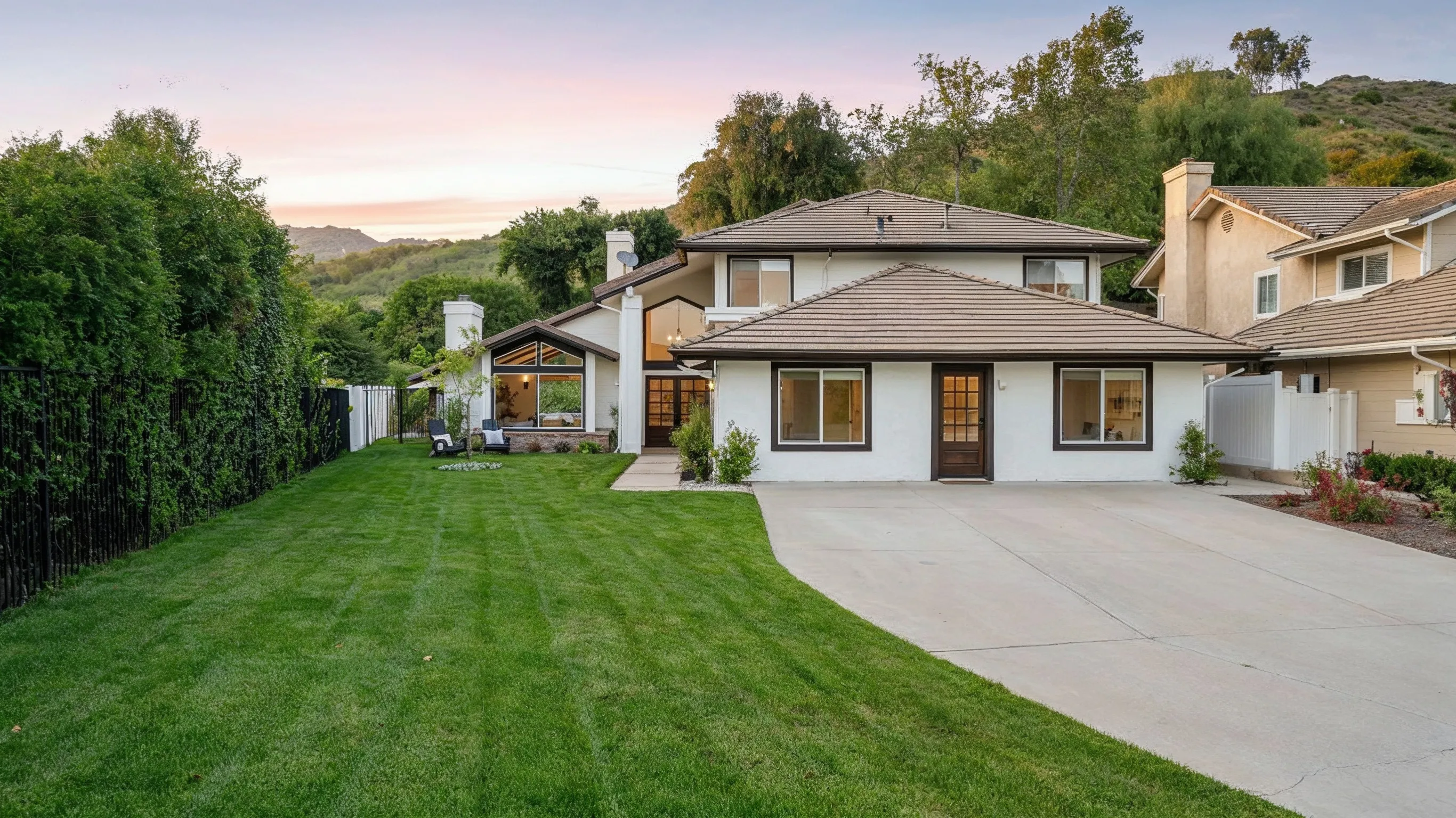 After photo of garage conversion ADU project in Los Angeles with remodeled home exterior, private entry access, driveway space, landscaped yard, and converted livable space