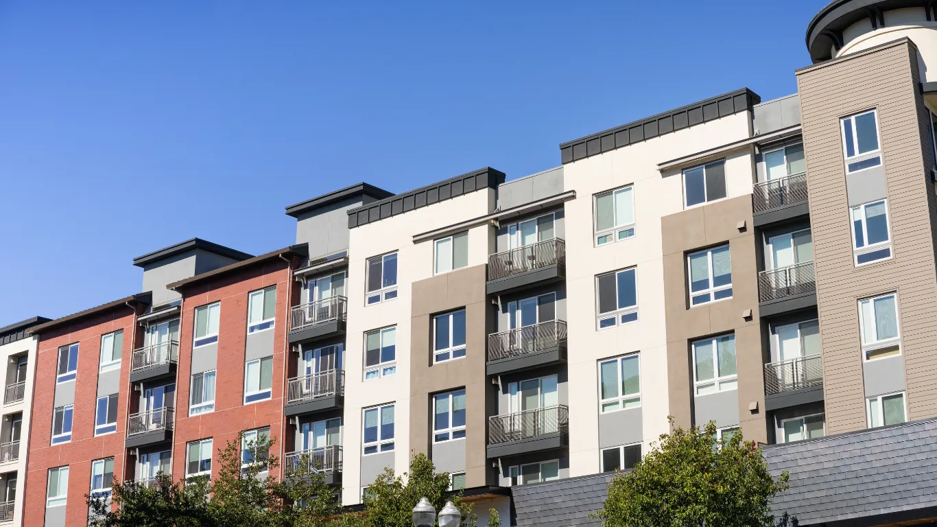 Condo remodeling project in Los Angeles with modern multi-unit building exterior, balconies, updated facade, residential windows, and urban condo renovation setting