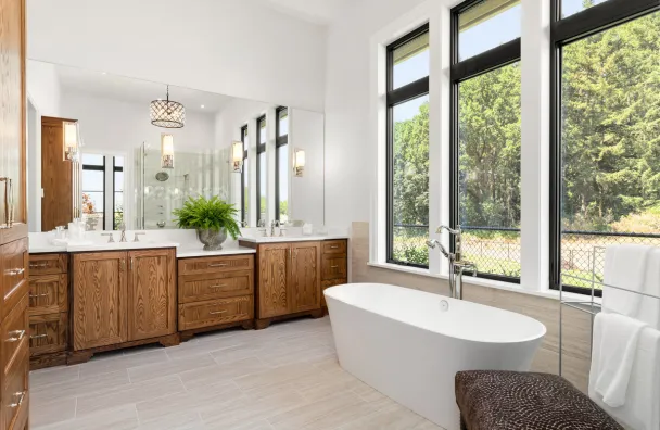 Bathroom remodeling in Los Angeles with freestanding bathtub, double vanity, large windows, natural light, tile flooring, and modern spa-style layout