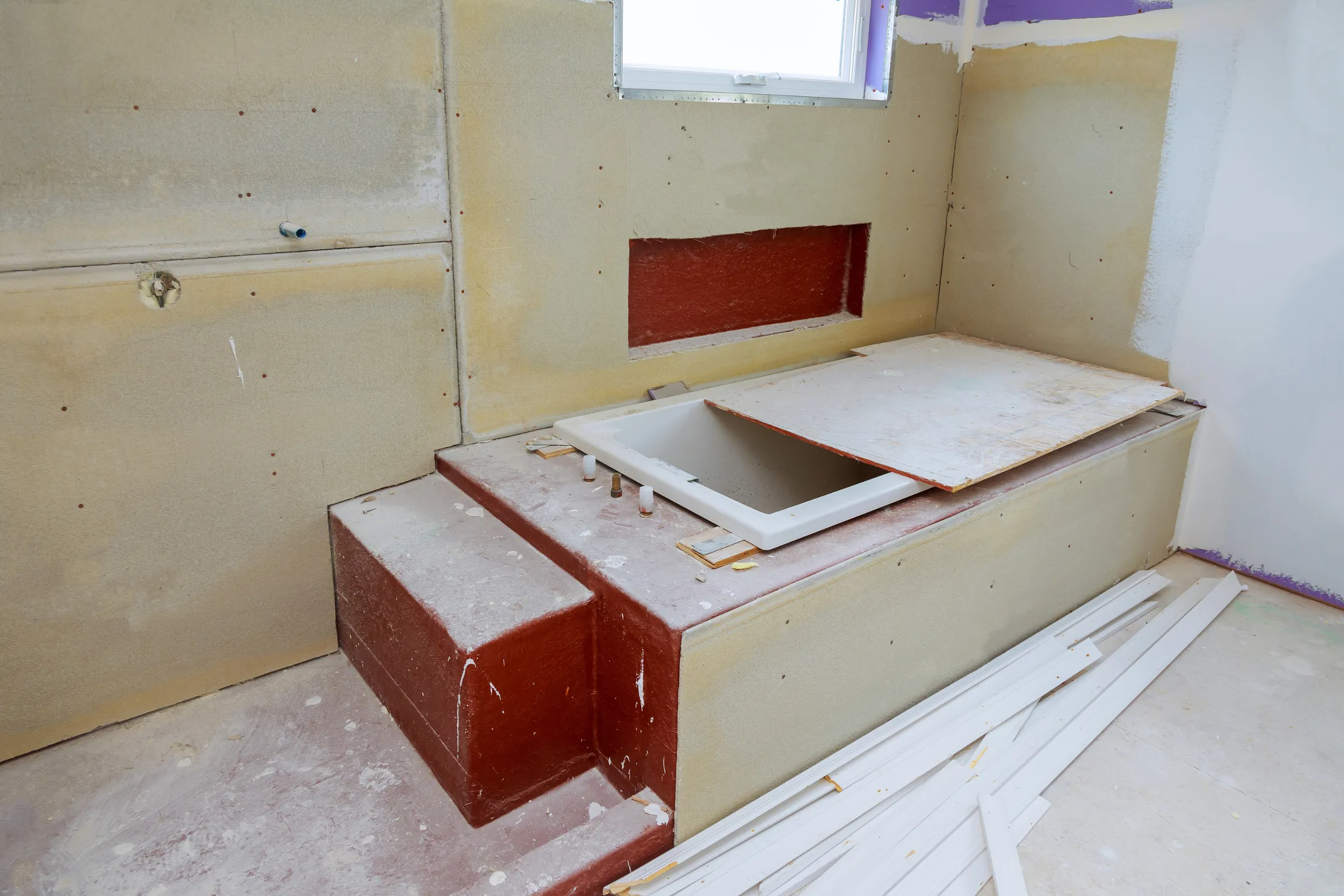 Bathroom remodeling in Los Angeles with wall preparation, tub installation area, waterproofing surfaces, plumbing openings, and renovation work in progress