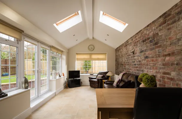 Room addition in Los Angeles with bright family room extension, vaulted ceiling, skylights, large windows, and new connected living space